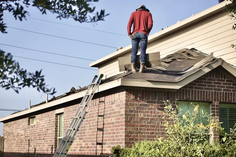 Professional roofer working on a residential roof in Trumbauersville